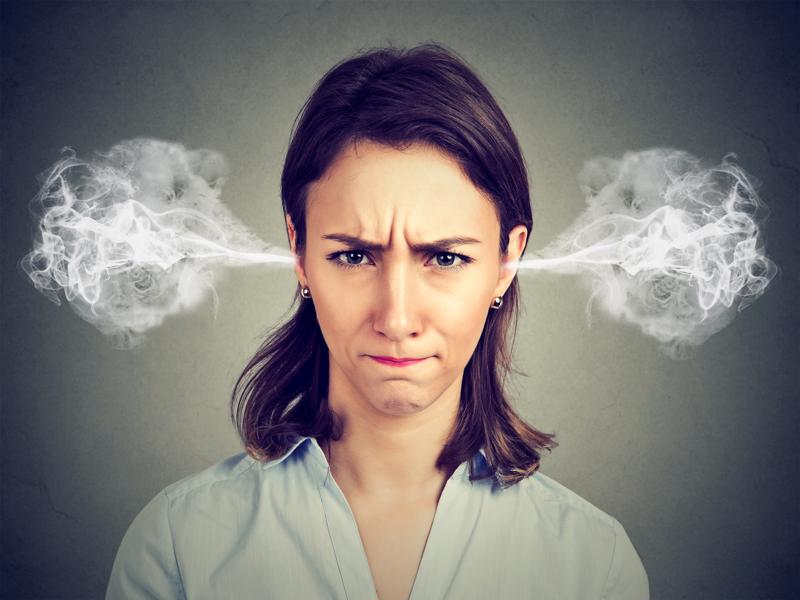 Annoyed woman with steam coming out of her ears