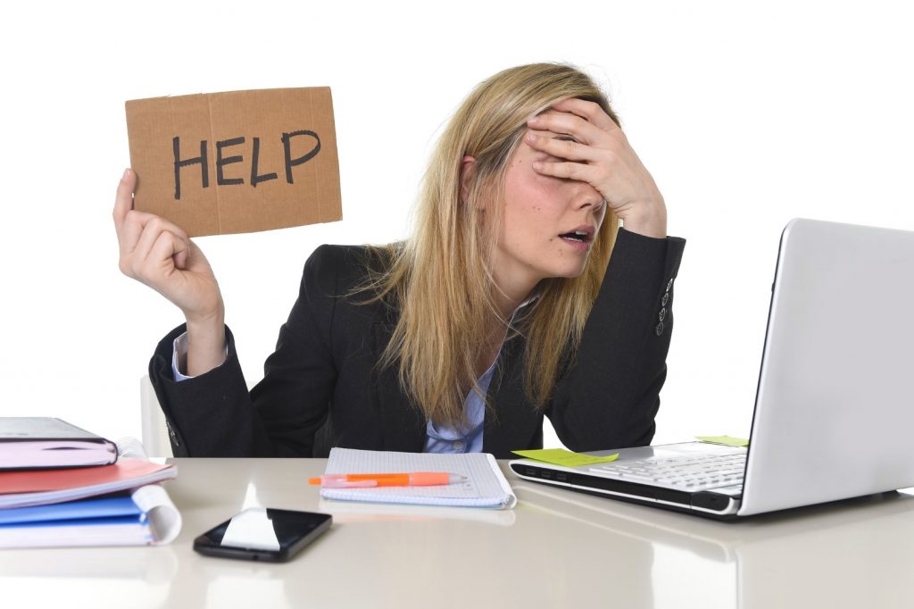 young beautiful business woman suffering stress working at office computer desk asking for help feeling tired and desperate looking overworked covering eyes overwhelmed and frustrated