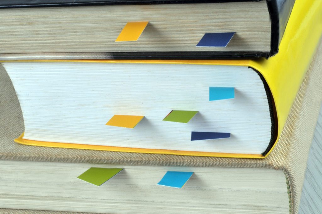 Stack of books with bookmarks showing which covers one of the Bad Computing Habits I see every day.