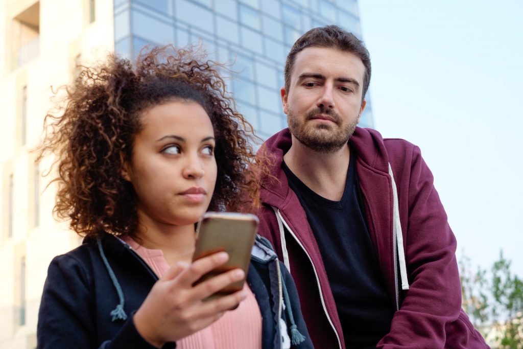 Guy looking at a woman's phone