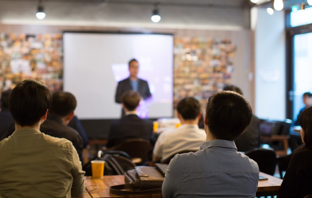 computer class seminar - man upfront teaching