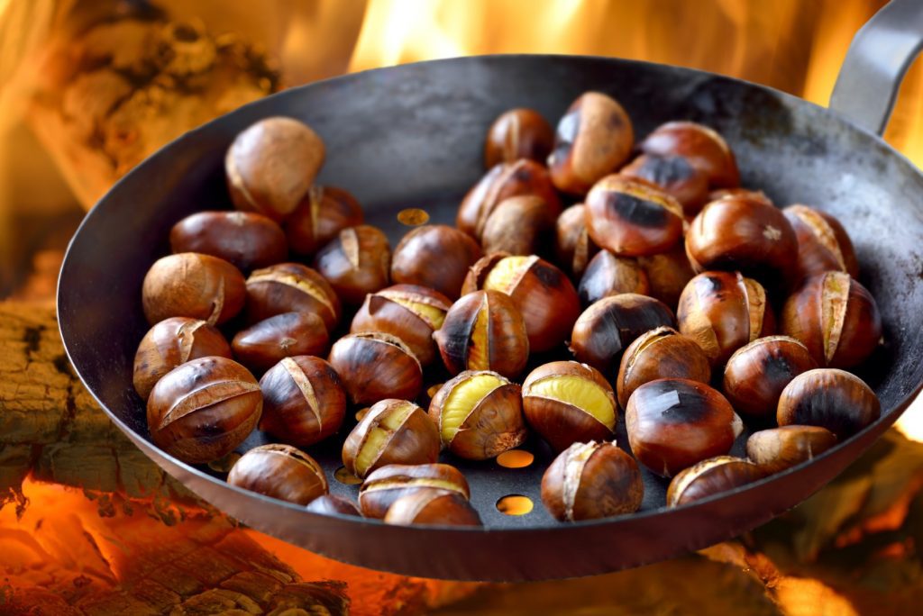 Chestnuts roasting on an open fire.
