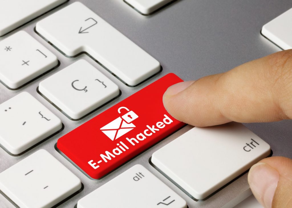 A keyboard showing a key in red "E-Mail hacked."