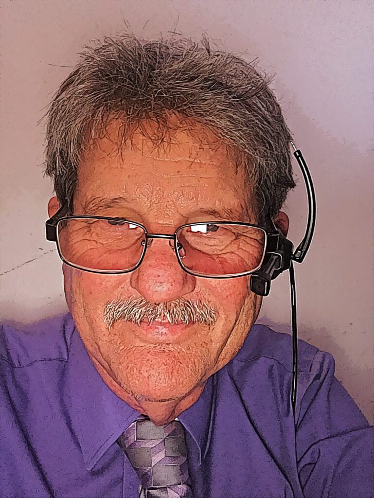 John Grubb wearing headset and glasses but with a cartoon effect filter applied.