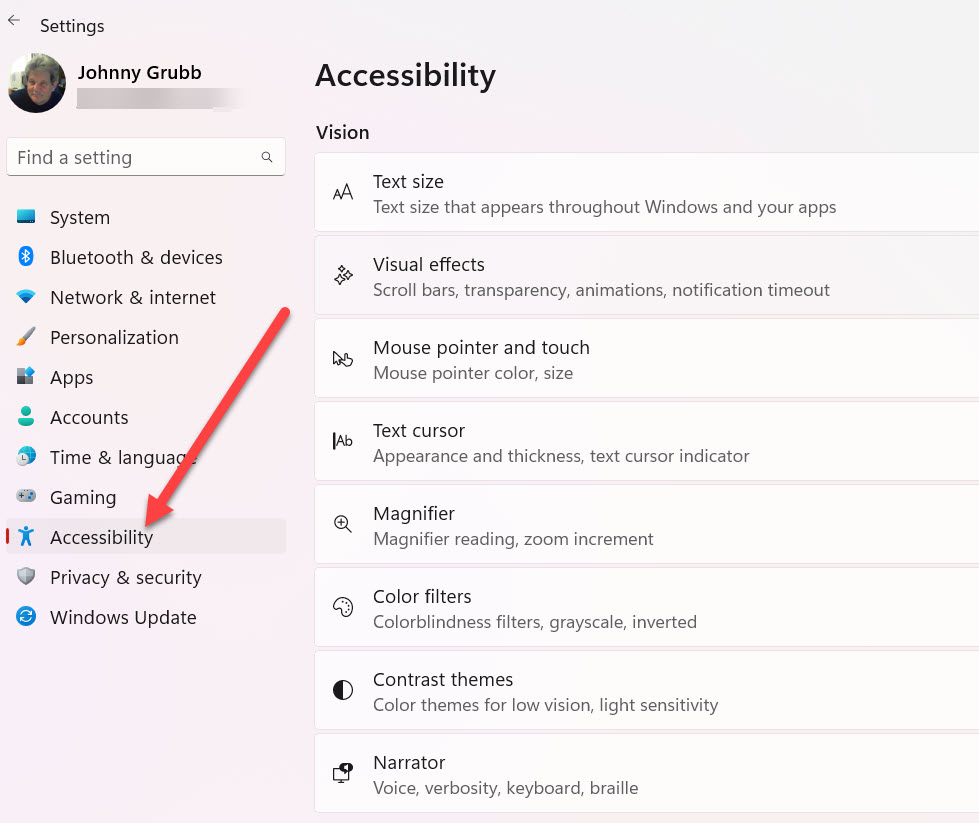 Windows 11 main Settings window with arrow pointing to accessibility.